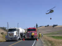 Sun 10 - Water from farm truck to fire truck to tank for helicopter.